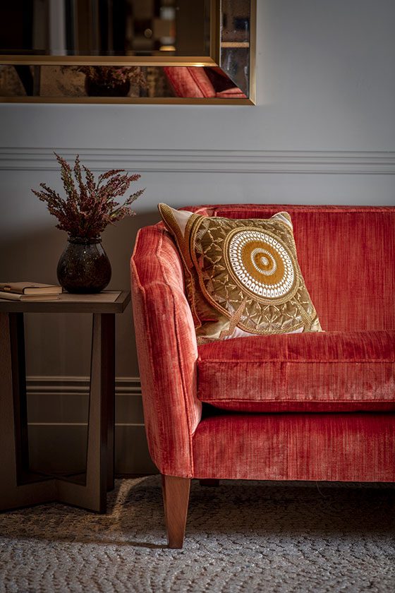 Josephine sofa in Como Pompeiian red detail with Ettore cushion - beaumont-&-fletcher